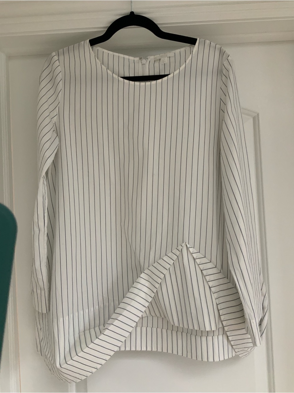COS white pinstripe blouse featuring a unique asymmetric hem detail